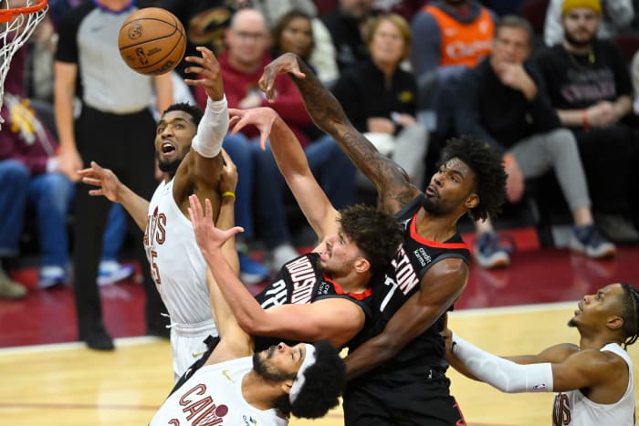 Cavaliers guard Donovan Mitchell and center Jarrett Allen reach for a rebound beside Rockets center Alperen Sengun and forward Tari Eason.